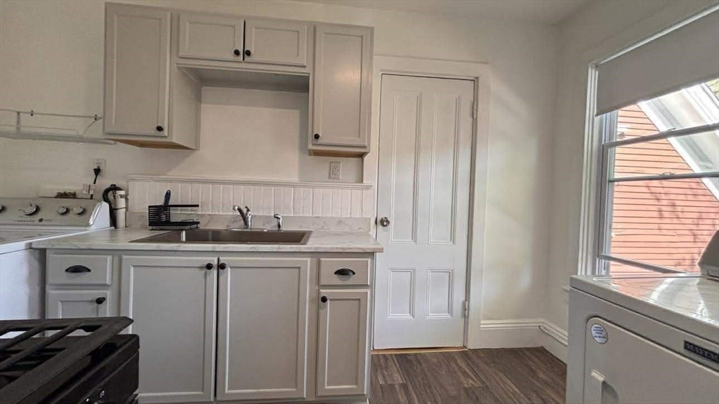 93 Peirce Street, Unit 2 Middleboro, MA 02346 - Photo 4 of 16 a kitchen with stainless steel appliances granite countertop a sink stove and refrigerator