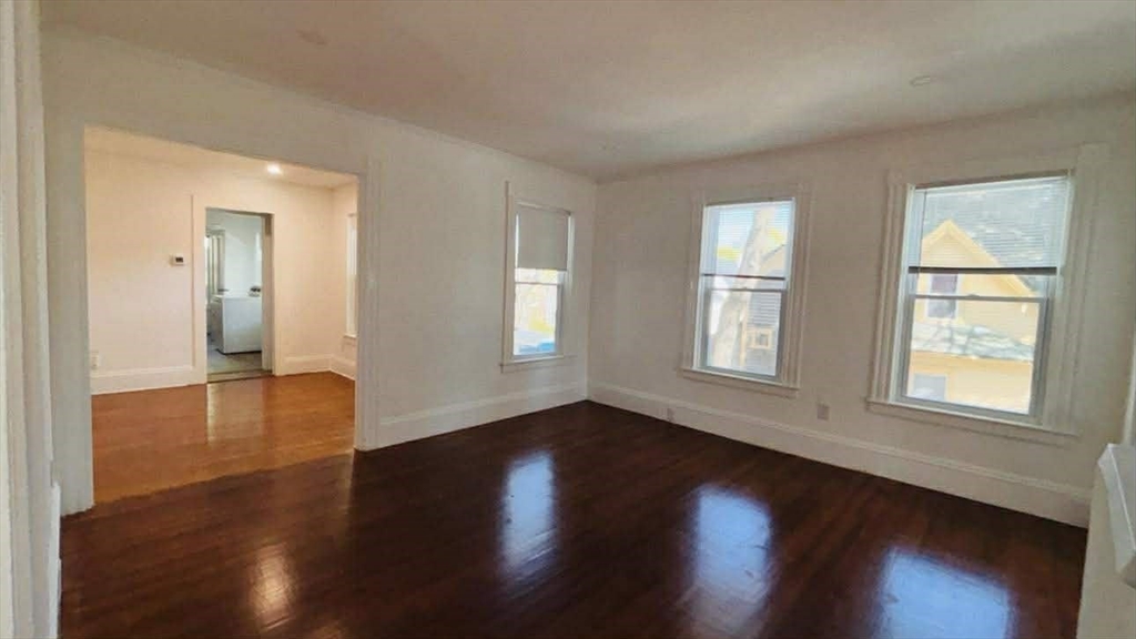 93 Peirce Street, Unit 2 Middleboro, MA 02346 - Photo 8 of 16 a view of an empty room with wooden floor and a window
