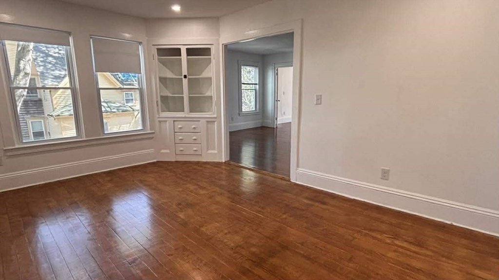 93 Peirce Street, Unit 2 Middleboro, MA 02346 - Photo 9 of 16 a view of an empty room with wooden floor and a window