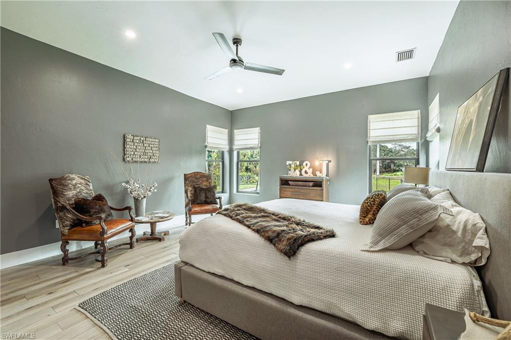 4269 15th Avenue Southwest Naples, FL 34116 - Photo 20 of 30 a bedroom with a bed and wooden floor
