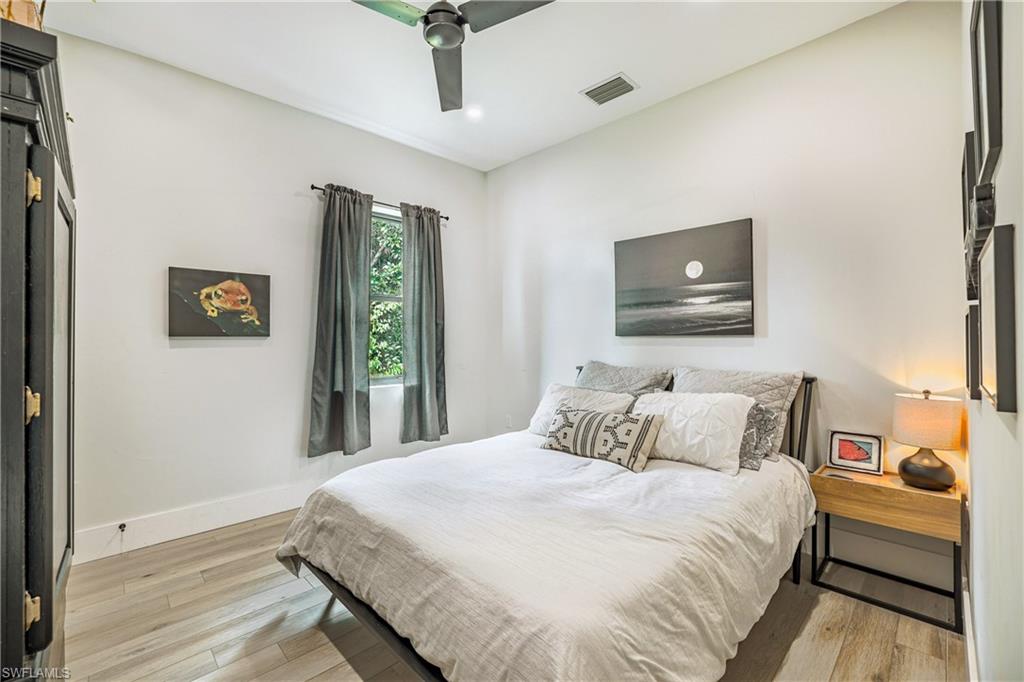 4269 15th Avenue Southwest Naples, FL 34116 - Photo 25 of 30 a bedroom with a bed and a tv