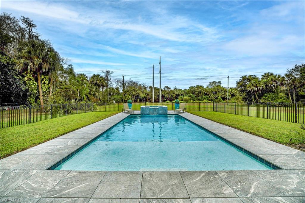 4269 15th Avenue Southwest Naples, FL 34116 - Photo 5 of 30 a view of a swimming pool with a lounge chairs