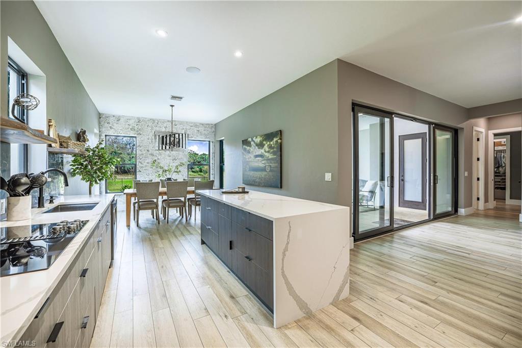 4269 15th Avenue Southwest Naples, FL 34116 - Photo 9 of 30 a living room with furniture and wooden floor