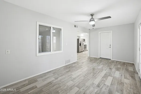 wooden floor in an empty room with a window