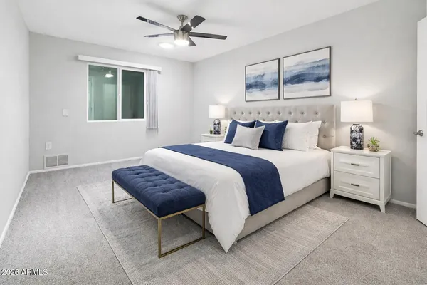 a bedroom with a bed and a chandelier