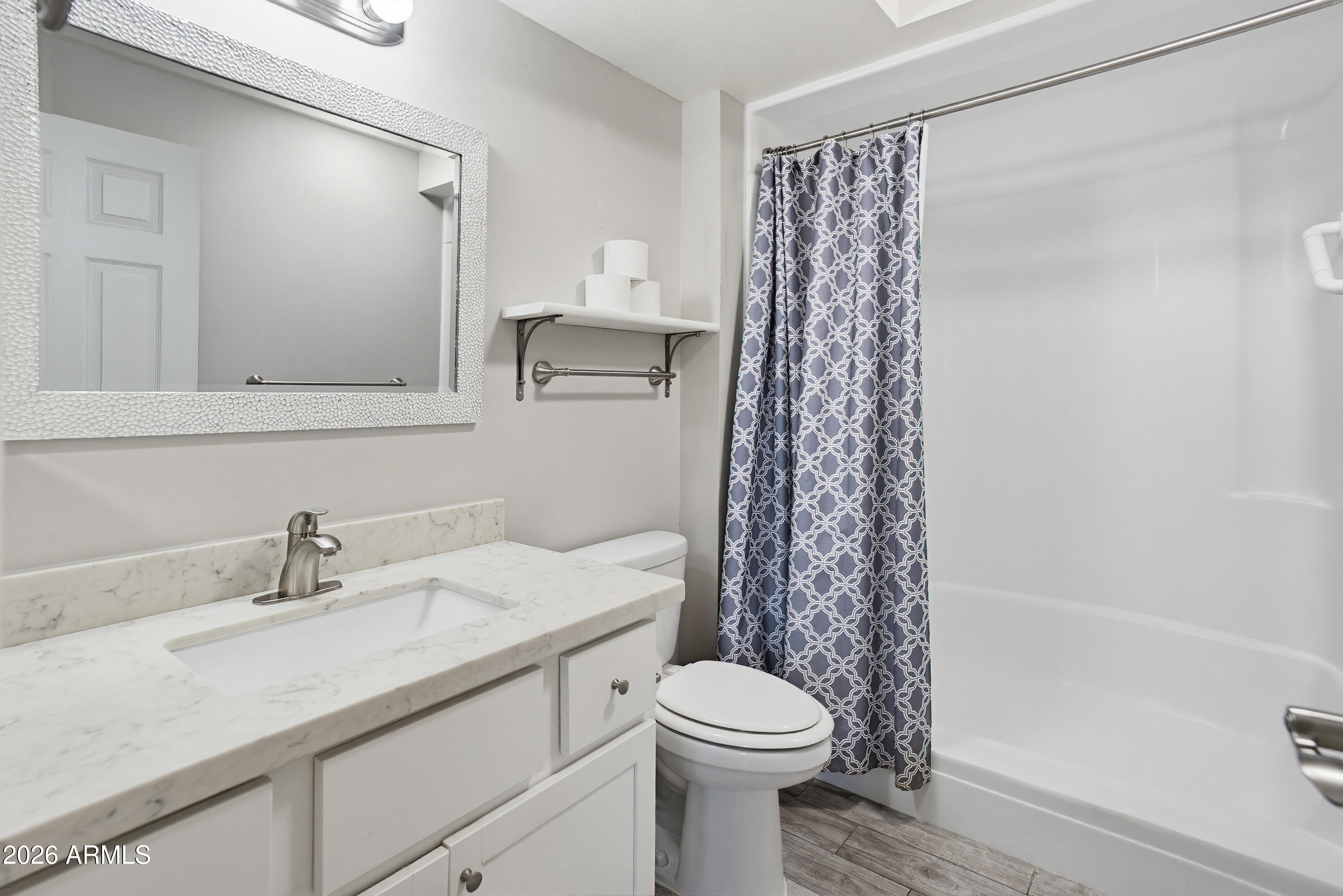 10030 West Royal Oak Road, Unit L Sun City, AZ 85351 - Photo 19 of 30 a bathroom with a sink a toilet and shower