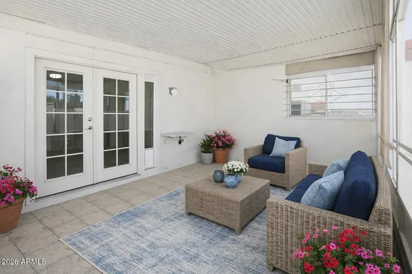 a living room with furniture and flowers