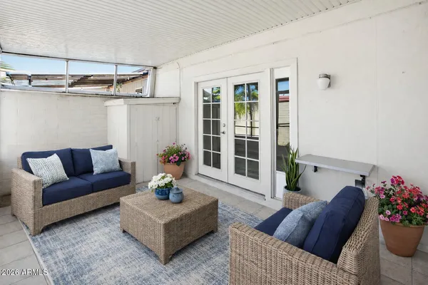 a living room with furniture and flowers