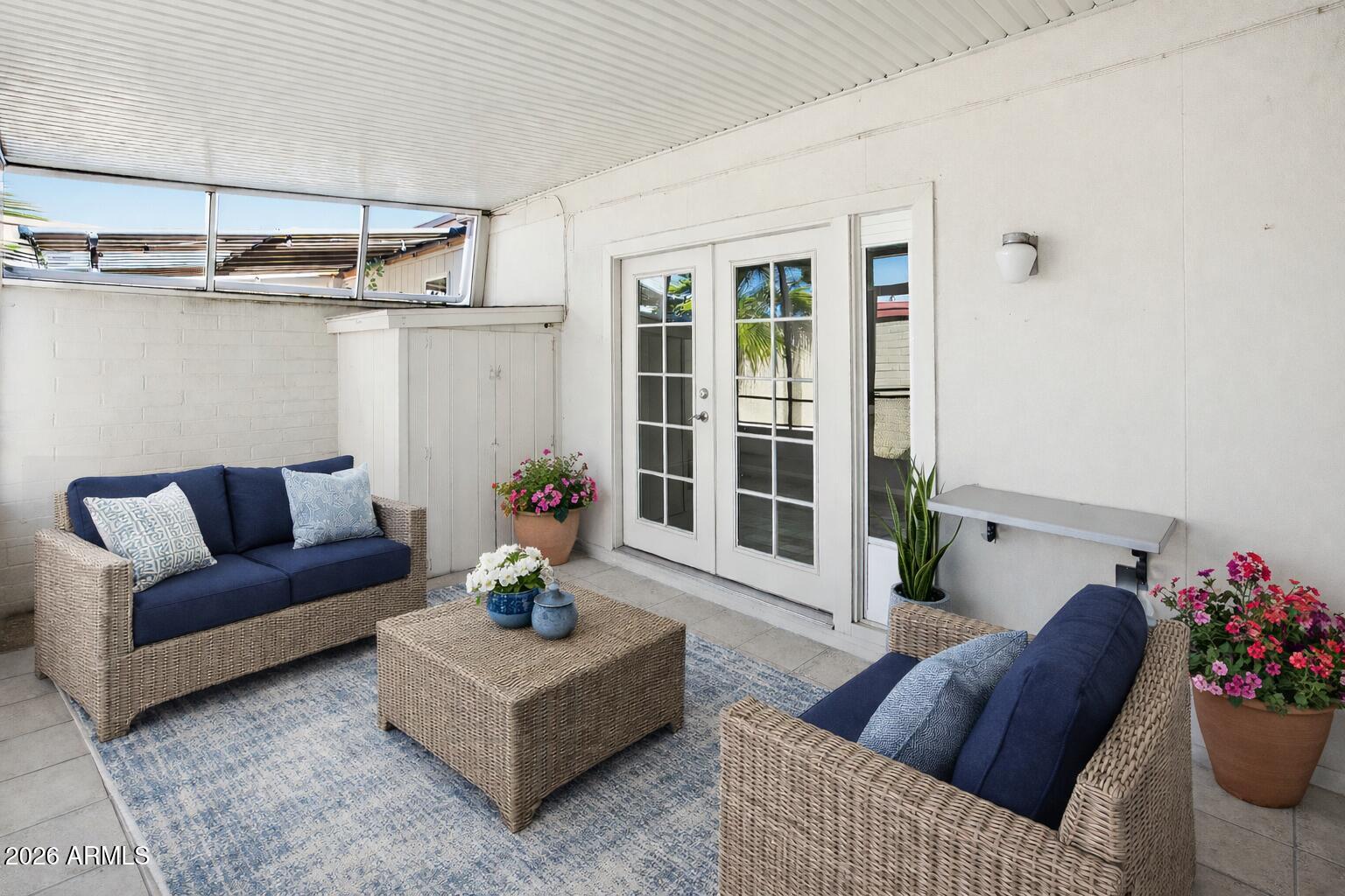 10030 West Royal Oak Road, Unit L Sun City, AZ 85351 - Photo 24 of 30 a living room with furniture and flowers