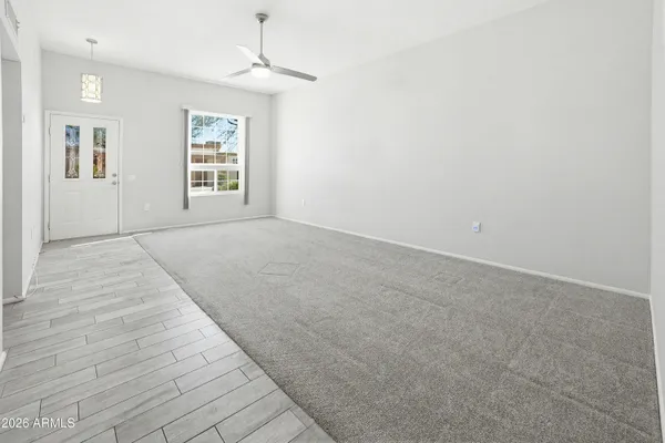 an empty room with windows and closet