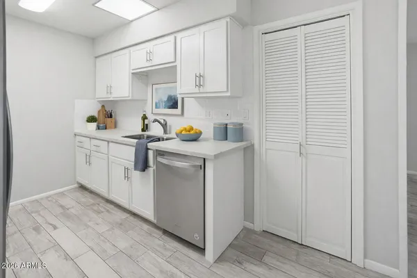 a utility room with cabinets washer and dryer