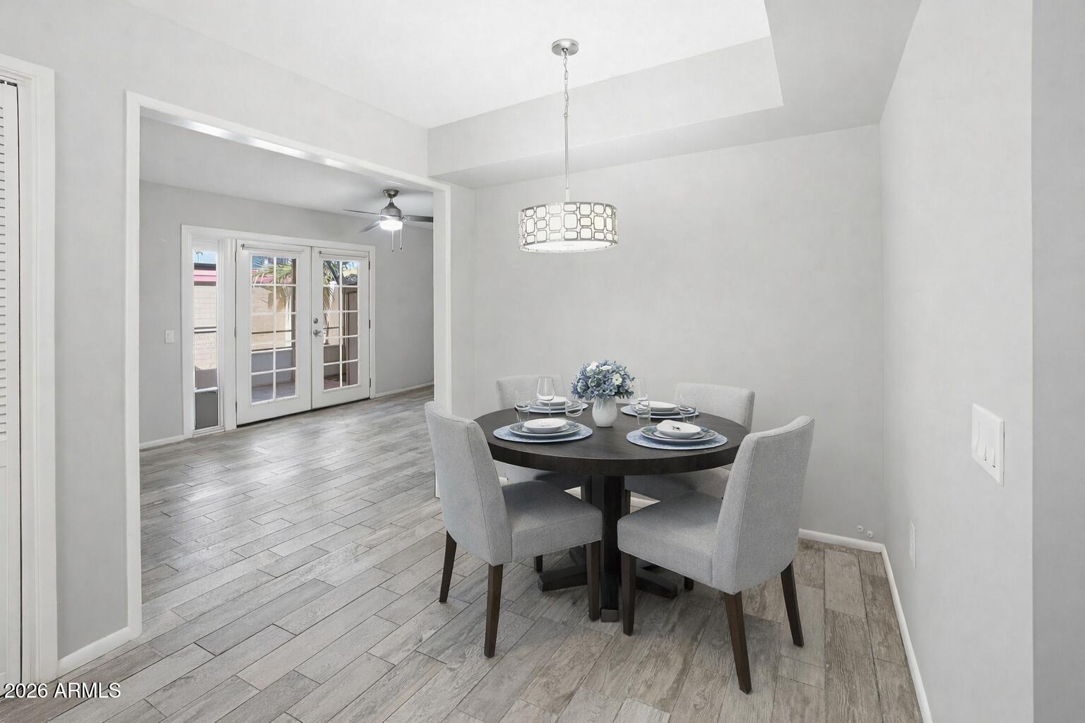 10030 West Royal Oak Road, Unit L Sun City, AZ 85351 - Photo 8 of 30 a view of a dining room with furniture and wooden floor