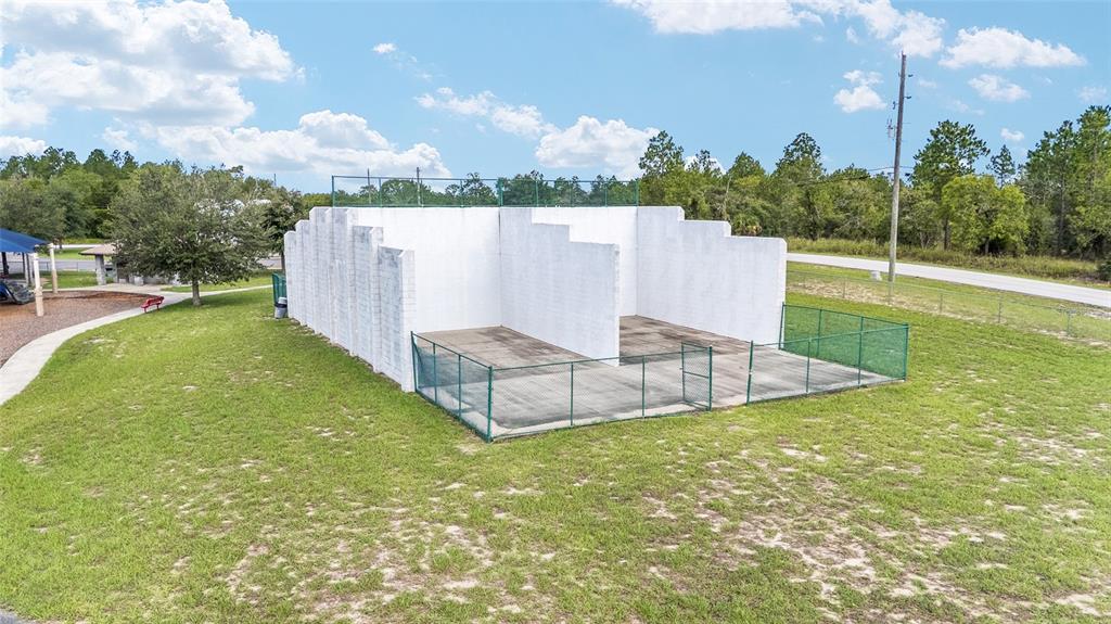 1922 Southwest Little Cliffs Drive Dunnellon, FL 34431 - Photo 31 of 37 a view of a house with a backyard and a garden