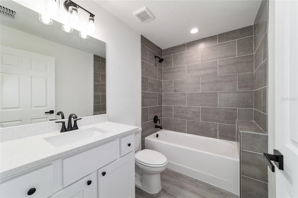 1922 Southwest Little Cliffs Drive Dunnellon, FL 34431 - Photo 8 of 37 a bathroom with a bathtub shower sink vanity mirror and toilet