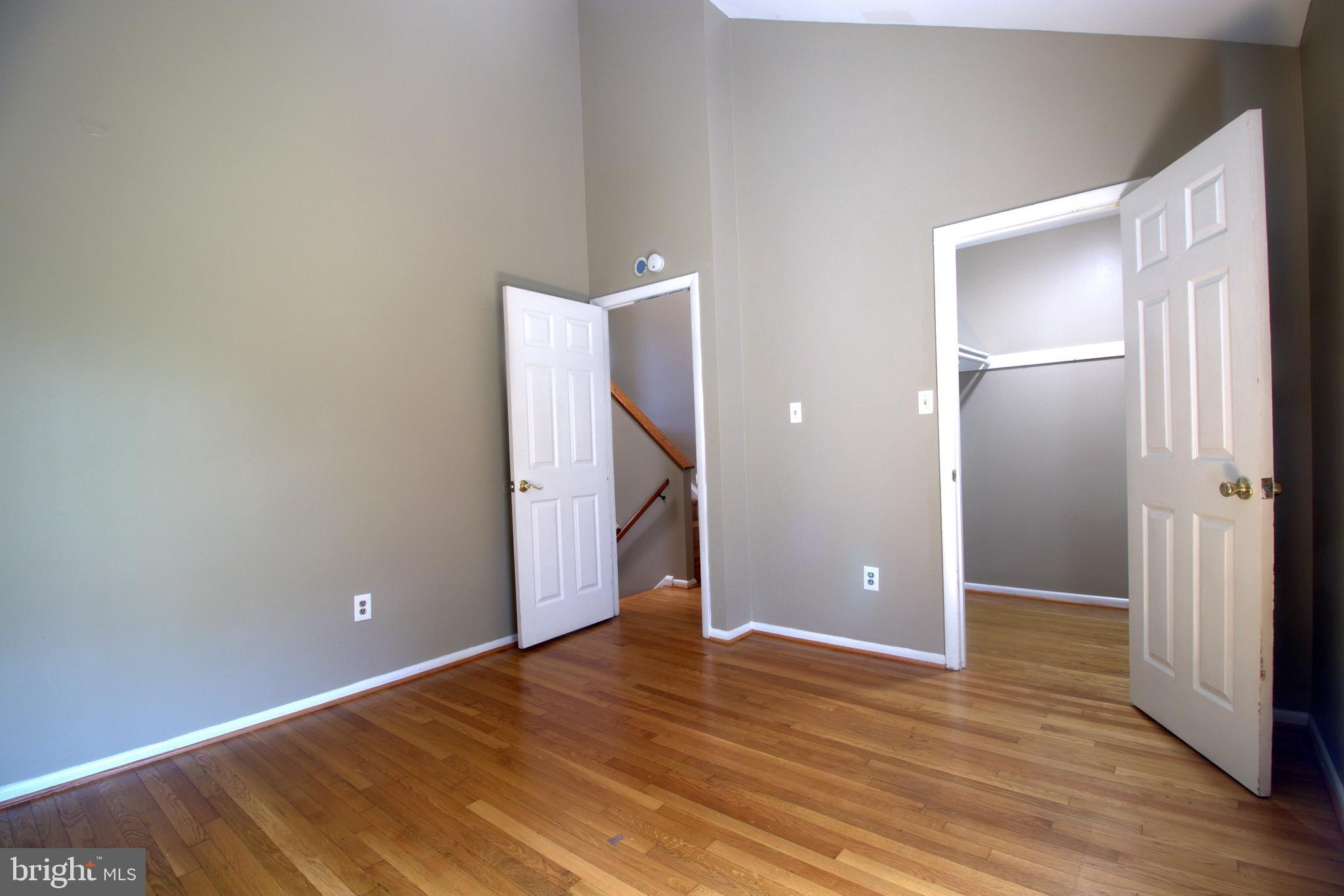9054 Canterbury Riding, Unit 147 Laurel, MD 20723 - Photo 9 of 15 a view of an empty room with wooden floor and a bathroom