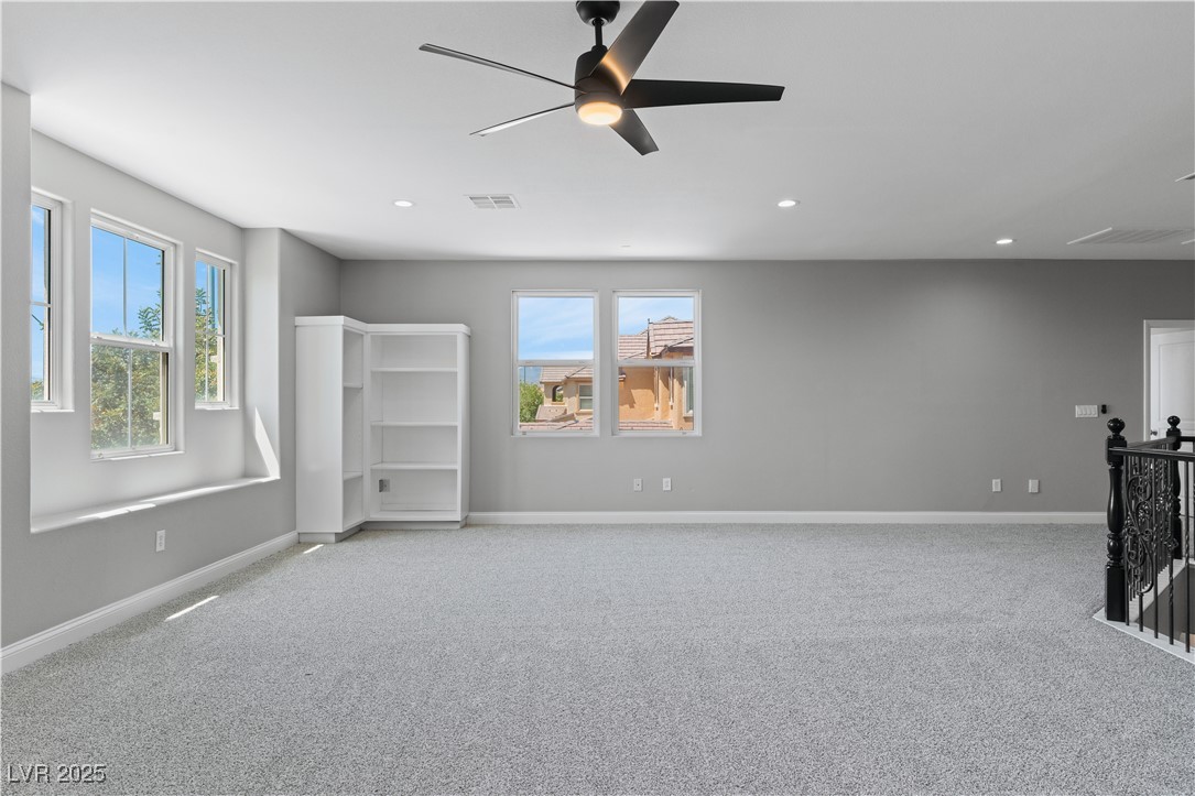 312 Pocono Ranch Avenue North Las Vegas, NV 89031 - Photo 24 of 34 Unfurnished living room featuring recessed lighting, visible vents, light colored carpet, and plenty of natural light