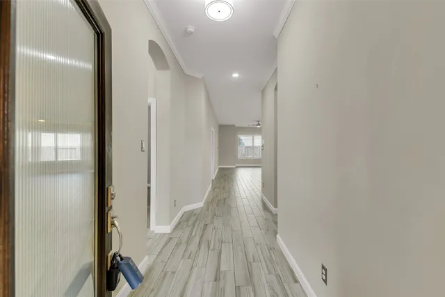 a view of a hallway with wooden floor