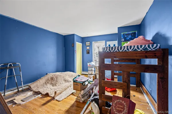 a bedroom with a bed and a book shelf