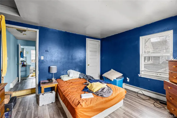 a bedroom with bed and a window