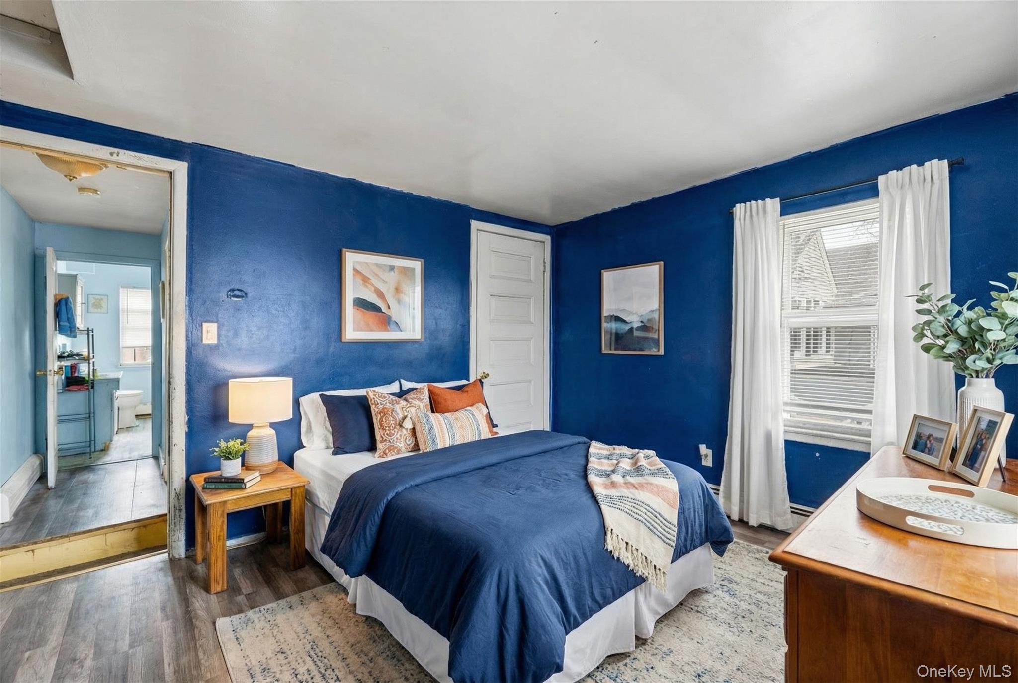 34 Mervin Street Inwood, NY 11096 - Photo 14 of 26 a bedroom with a bed and wooden floor