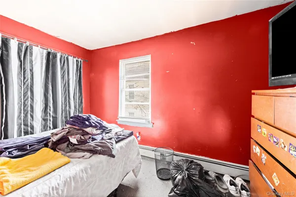 a bed room with a bed and a television