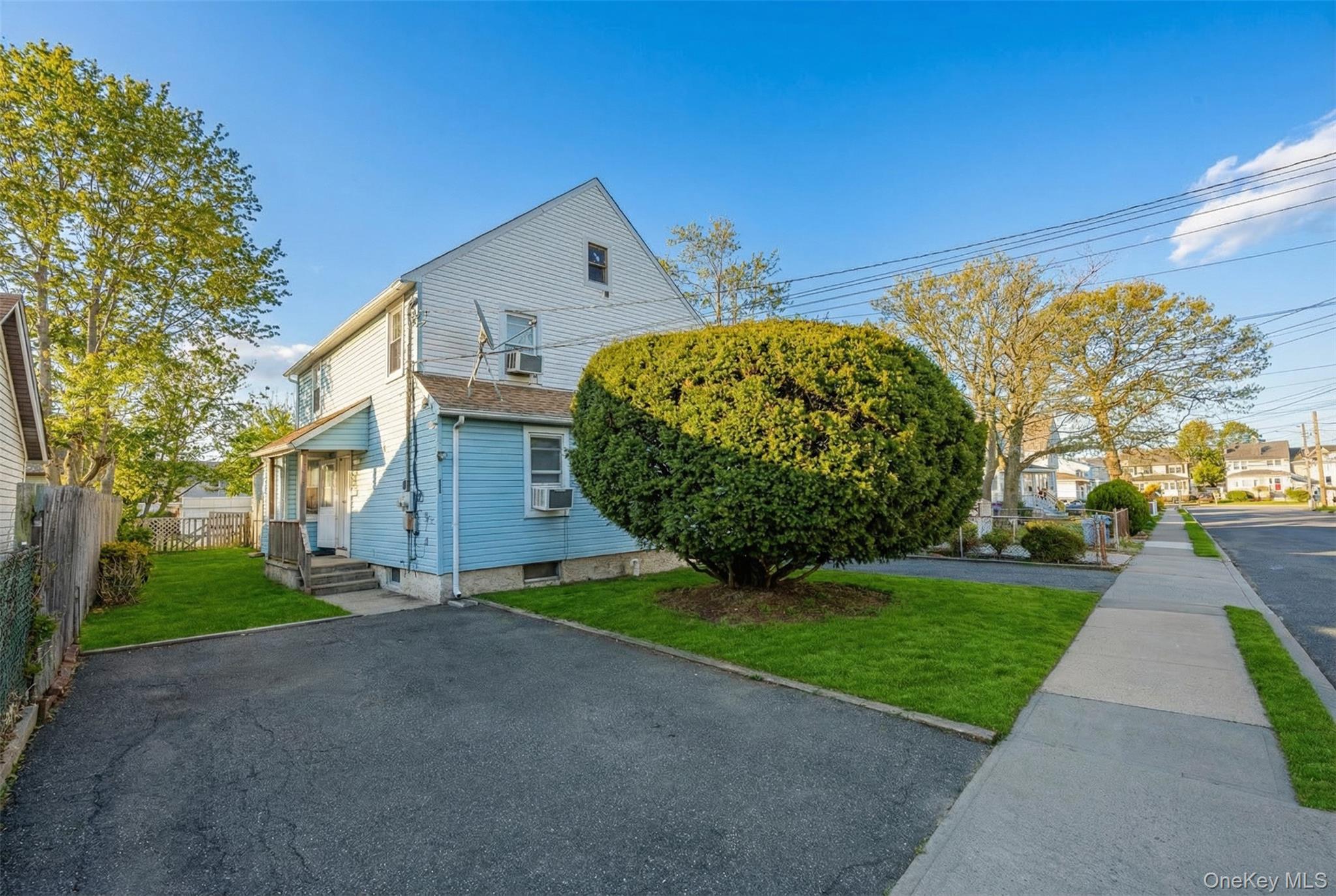 34 Mervin Street Inwood, NY 11096 - Photo 2 of 26 a front view of a house with garden