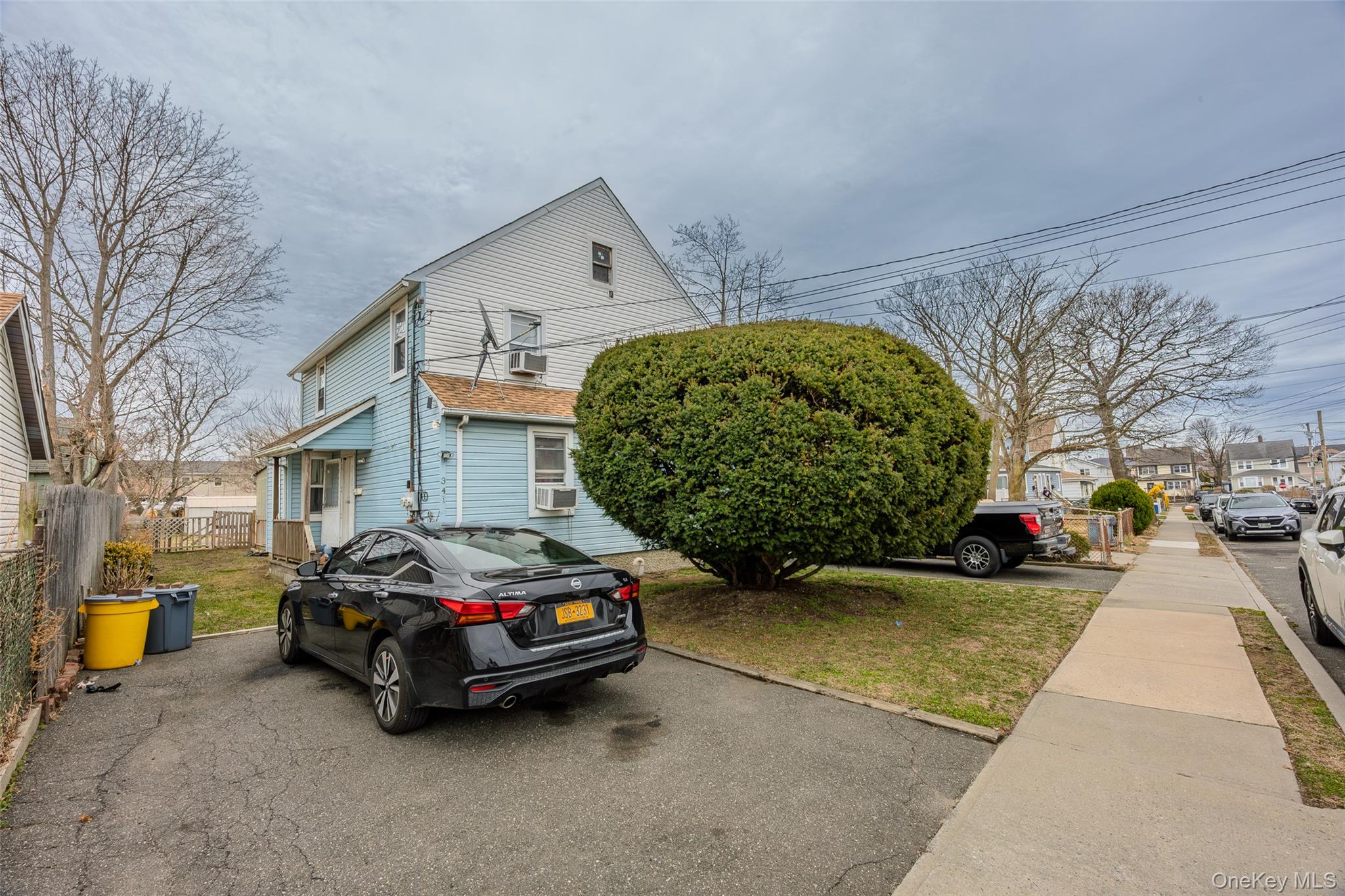 34 Mervin Street Inwood, NY 11096 - Photo 3 of 26 a car parked in front of a house