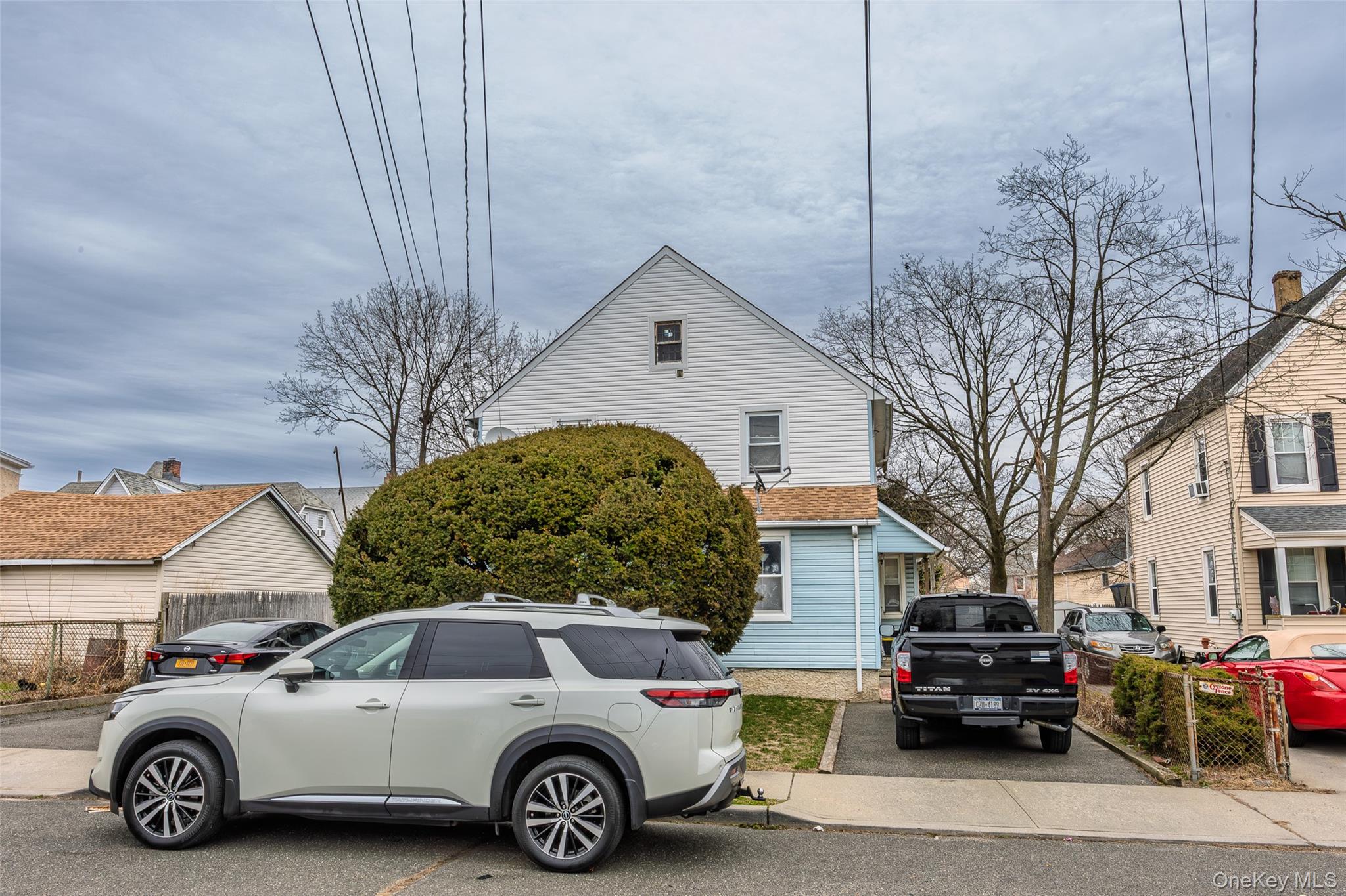 34 Mervin Street Inwood, NY 11096 - Photo 5 of 26 a car parked in front of a house