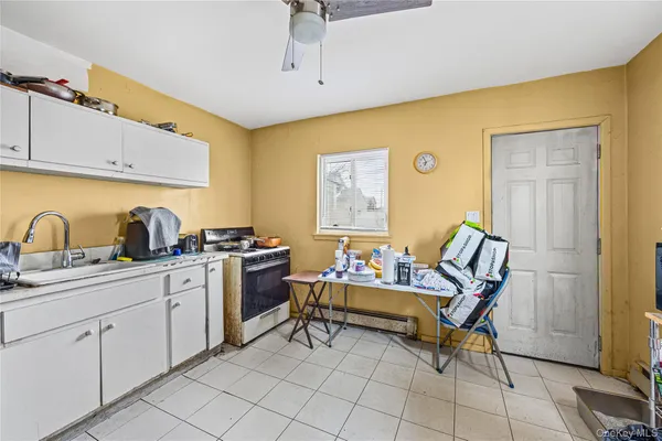 a kitchen with cabinets and chairs