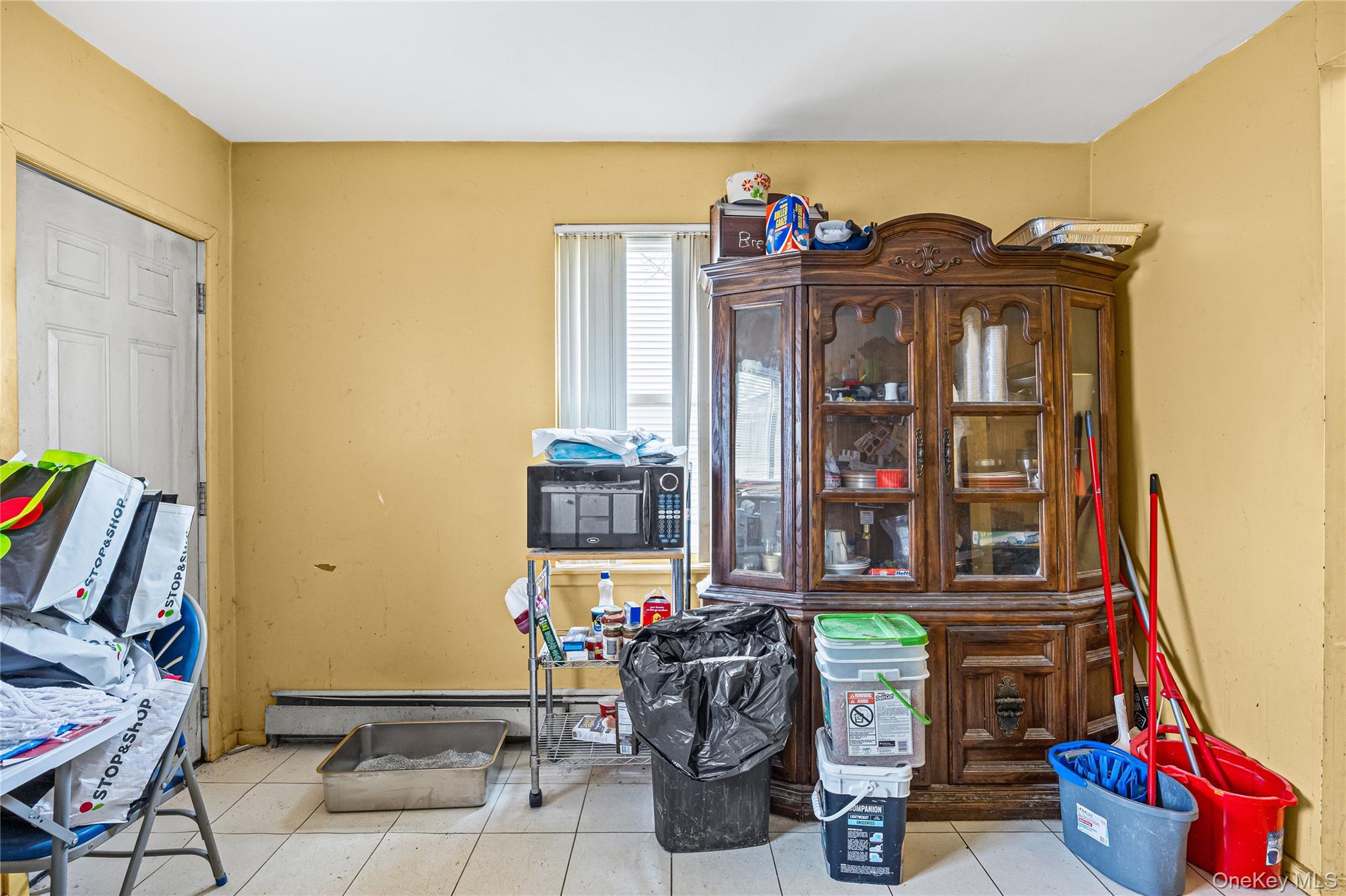 34 Mervin Street Inwood, NY 11096 - Photo 9 of 26 a living room with lots of furniture and a flat screen tv