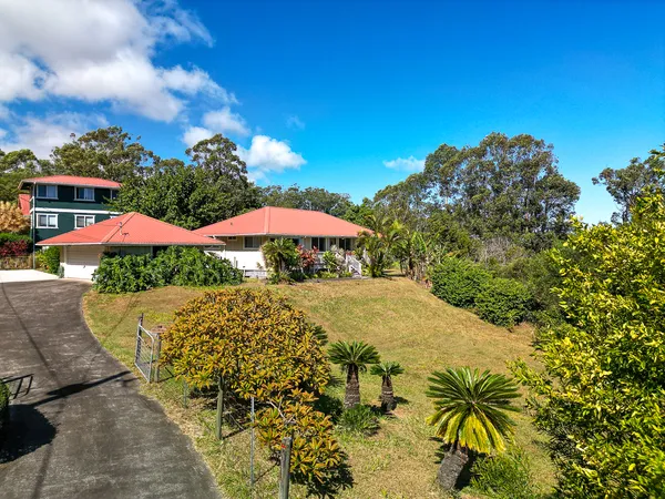 a view of a house with a yard and sitting area