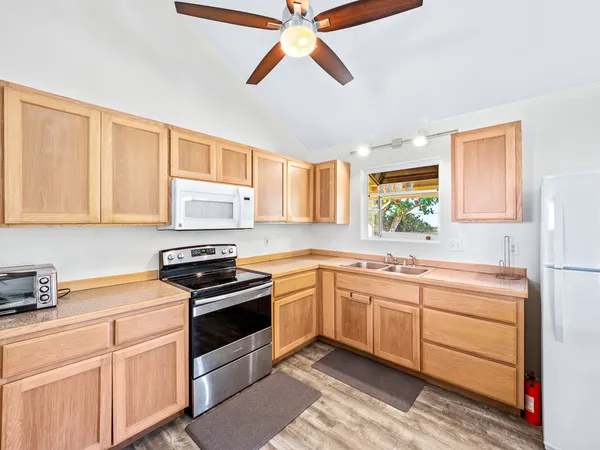a kitchen with stainless steel appliances a stove sink and cabinets