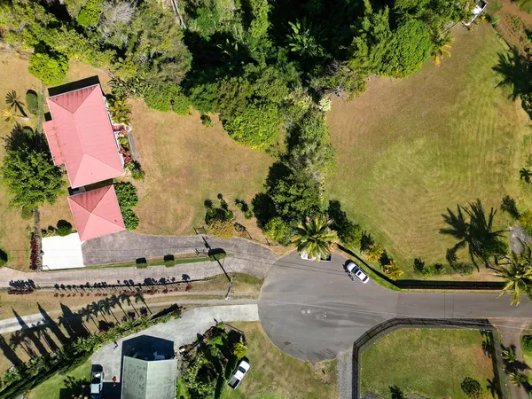 an aerial view of a house with a yard basket ball court and outdoor seating