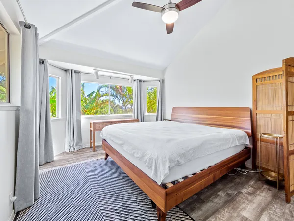 a bed sitting in a bedroom next to a window