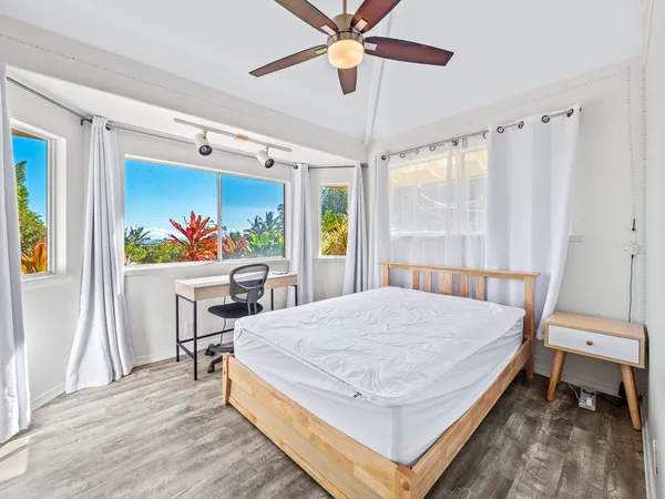 a bed room with a bed and a chair