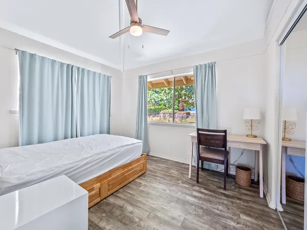 a bedroom with a bed and a desk