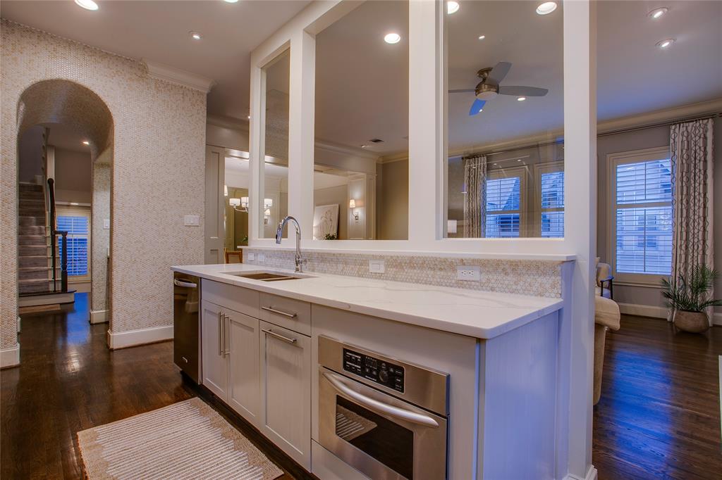 3810 Hawthorne Avenue Dallas, TX 75219 - Photo 22 of 40 a kitchen with a sink and a wooden floor