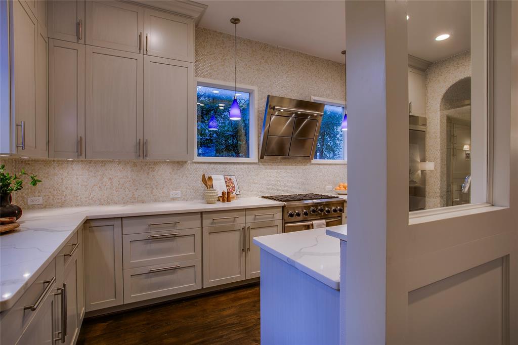 3810 Hawthorne Avenue Dallas, TX 75219 - Photo 23 of 40 a kitchen with a sink cabinets and wooden floor