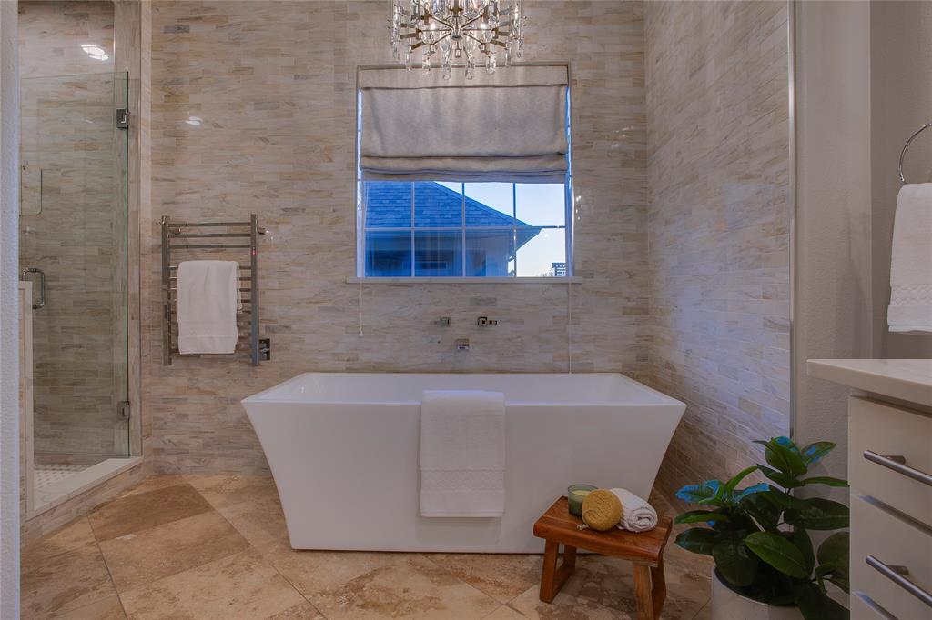 3810 Hawthorne Avenue Dallas, TX 75219 - Photo 30 of 40 a bath tub sitting in a bathroom next to a window