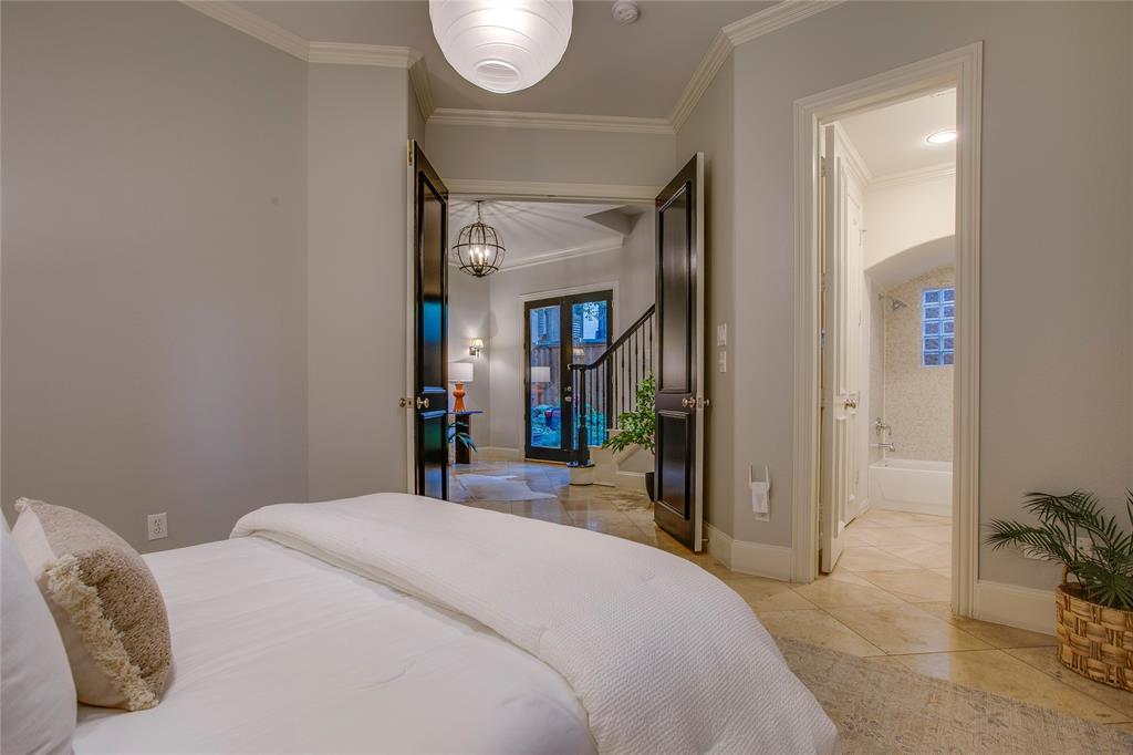 3810 Hawthorne Avenue Dallas, TX 75219 - Photo 10 of 40 a bedroom with a bed and a mirror