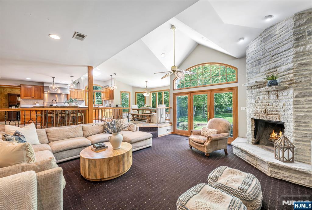 411 Snyder Road Wyckoff, NJ 07481 - Photo 12 of 36 a living room with furniture fireplace and a large window