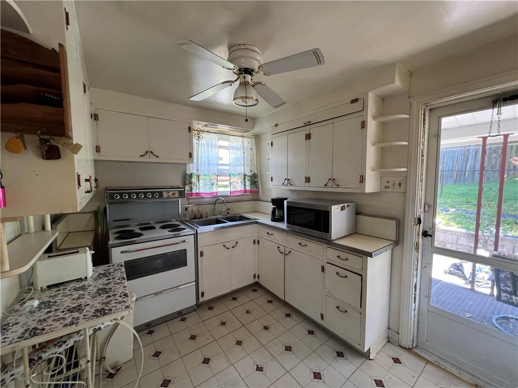 413 Rustic Road North Versailles, PA 15137 - Photo 10 of 20 a kitchen with a stove a sink and a refrigerator
