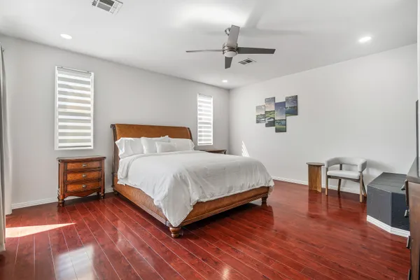 a bedroom with a bed and wooden floor