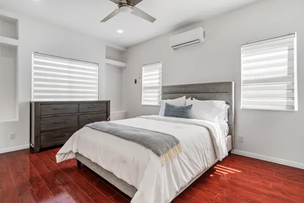 a bedroom with a bed and wooden floor