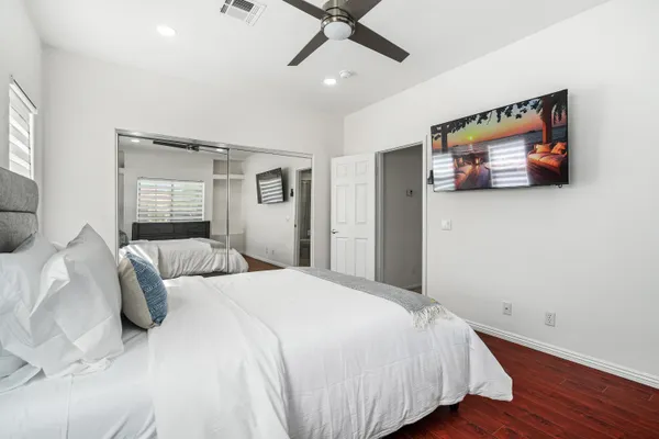 a bedroom with a bed and a flat screen tv