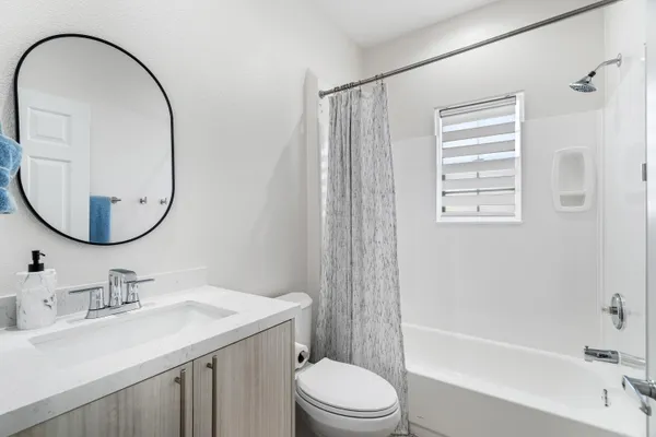 a bathroom with a sink a toilet and a mirror