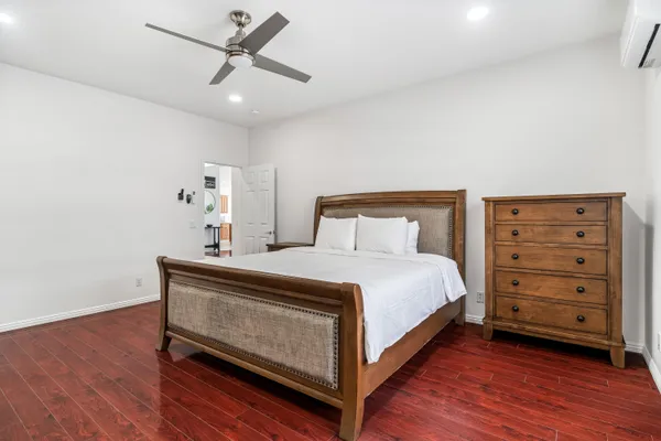 a bedroom with a bed and a ceiling fan