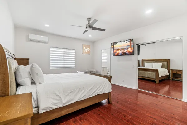 a bedroom with a bed and wooden floor
