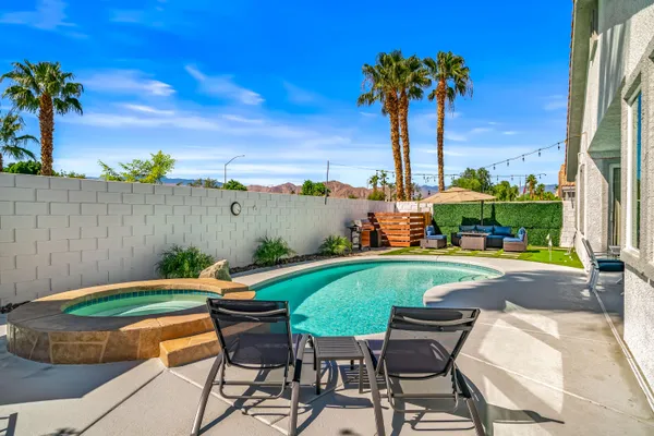 a view of a swimming pool with a table and chairs