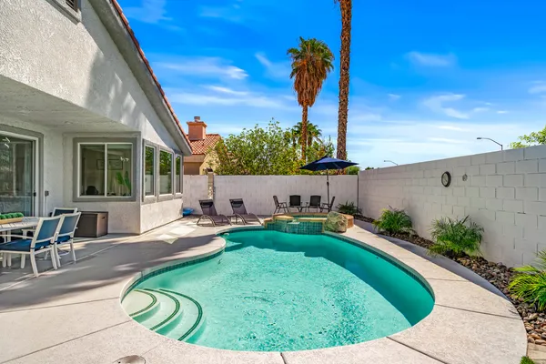 a view of a backyard with sitting area